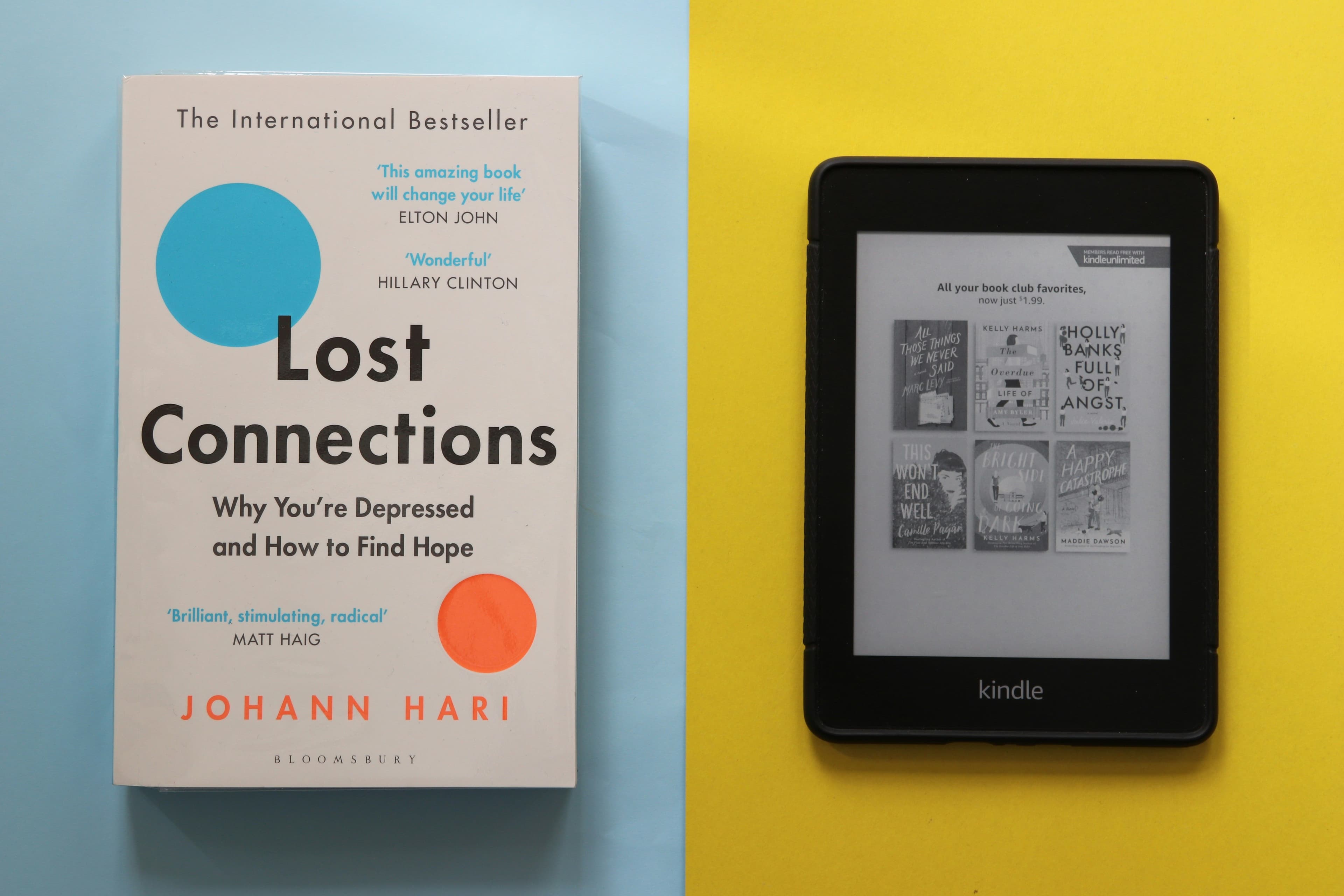 Main Image: A book (Lost Connections by Johann Hari) and a black Amazon Kindle